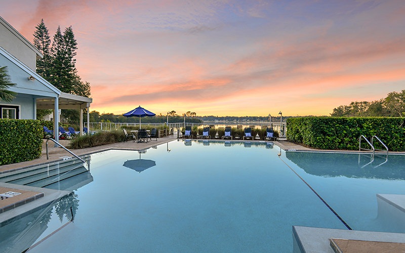 Spacious sparkling blue pool with large pool deck 
